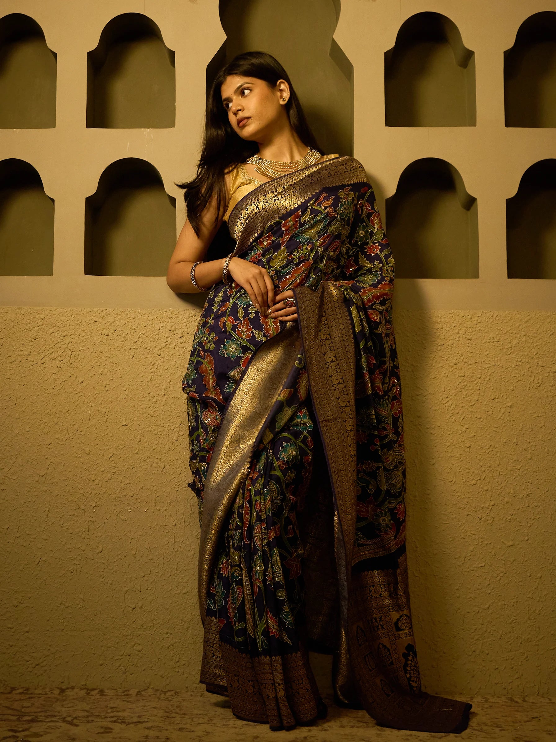 Broad gold Zardozi woven border running full length of navy blue Kalamkari soft silk sar
