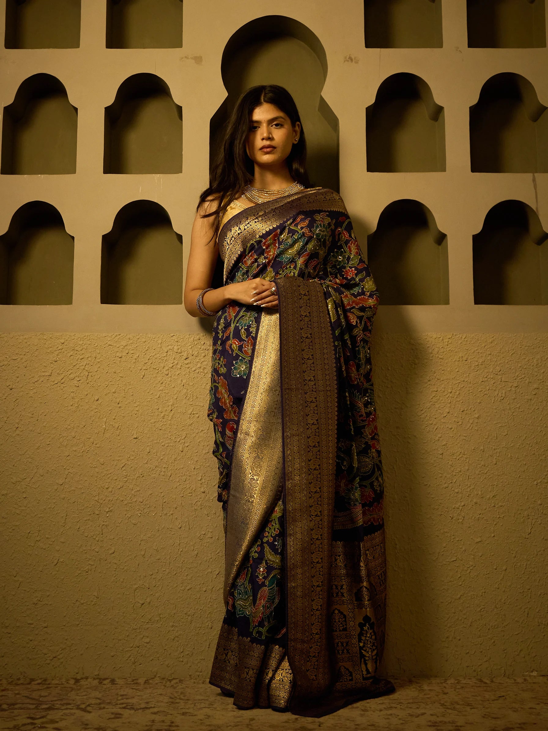 Close-up of Kalamkari hand-painted nature and floral motifs on navy blue soft silk saree fabric