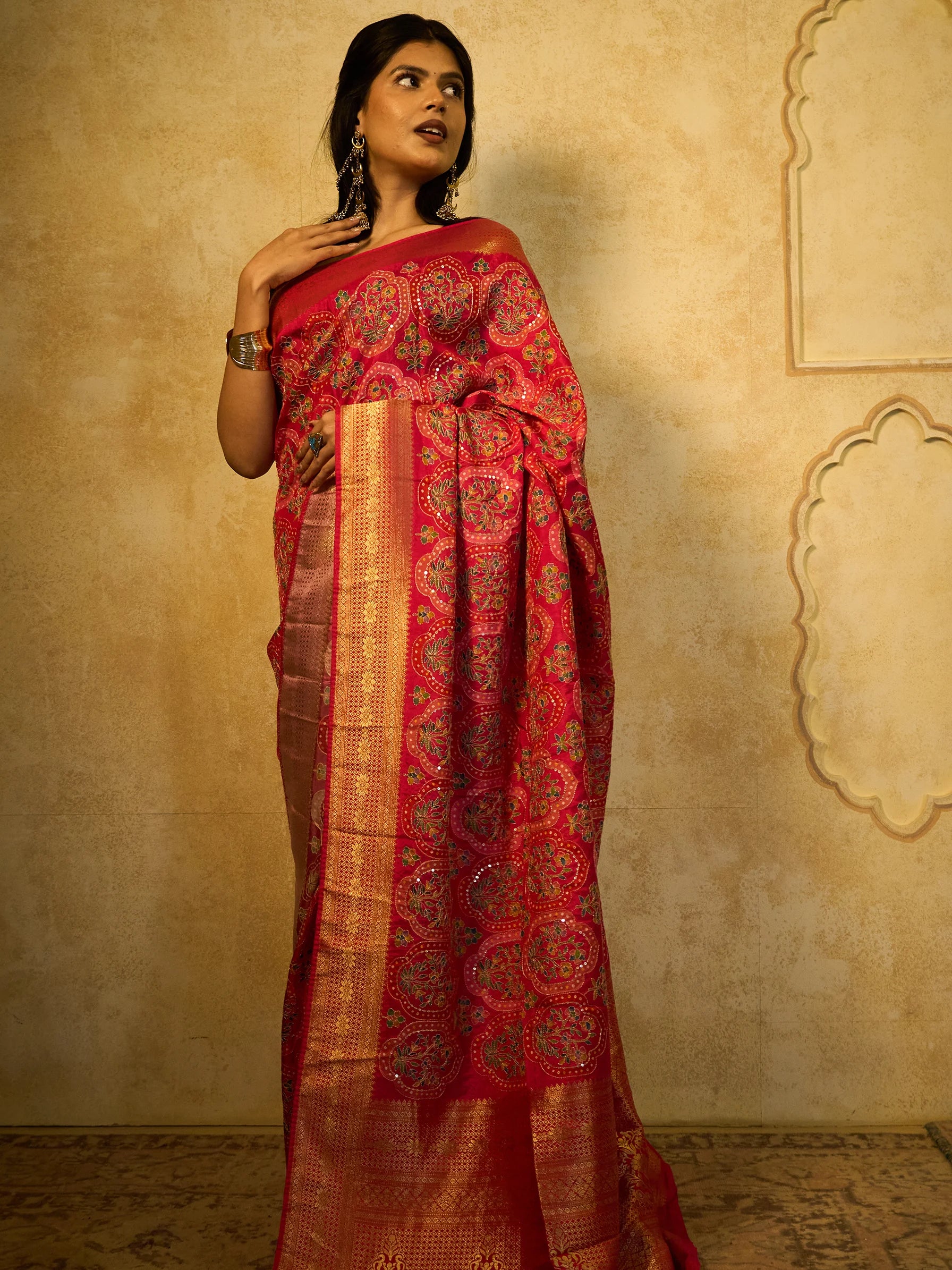 Close-up of scalloped Bandhani medallion jaal with Jamawar floral bouquet and sequin dot outline on pink Eri silk saree