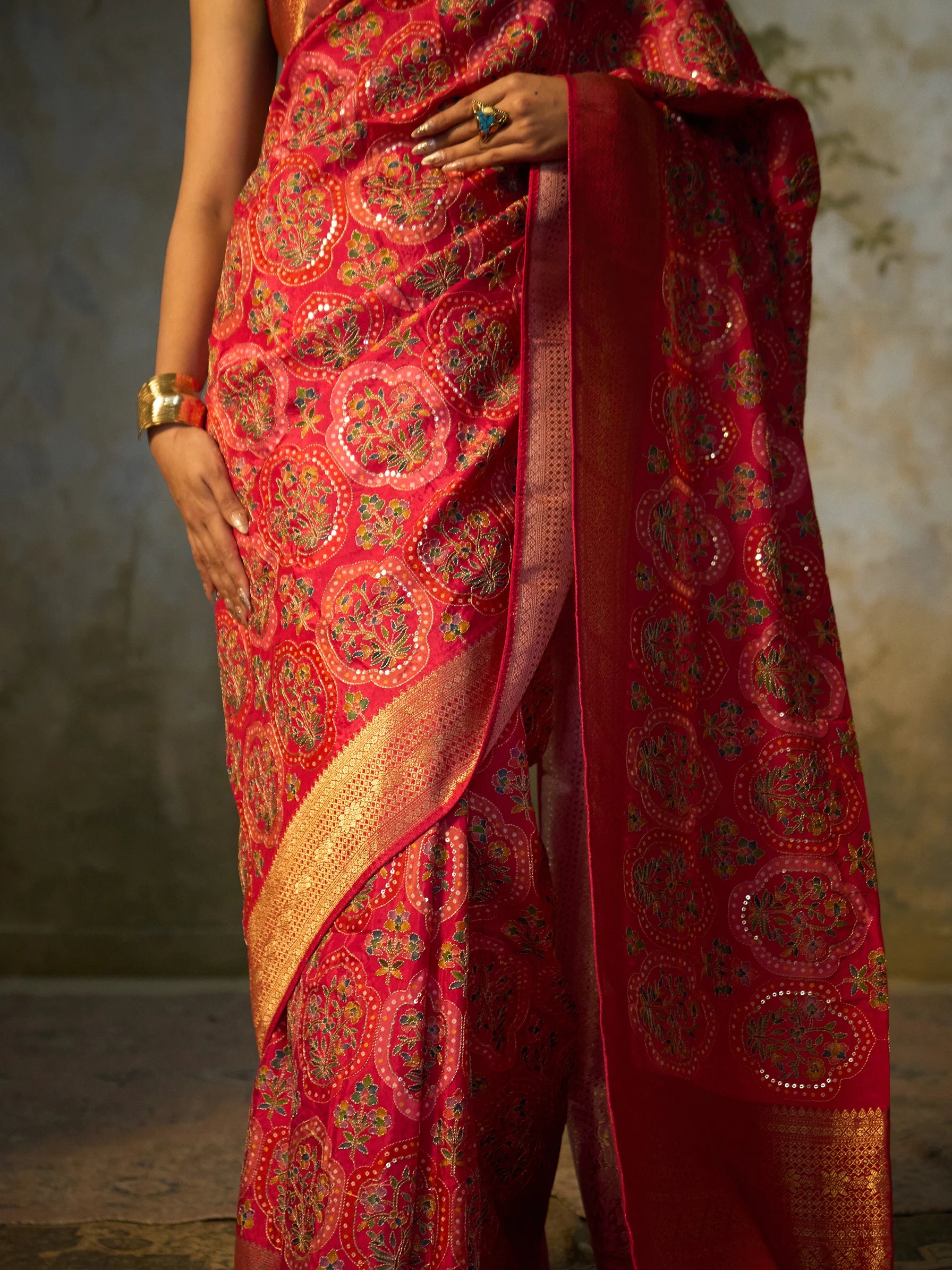 Broad gold Zari woven border and embroidered pallu of pink Bandhani Jamawar Eri silk saree