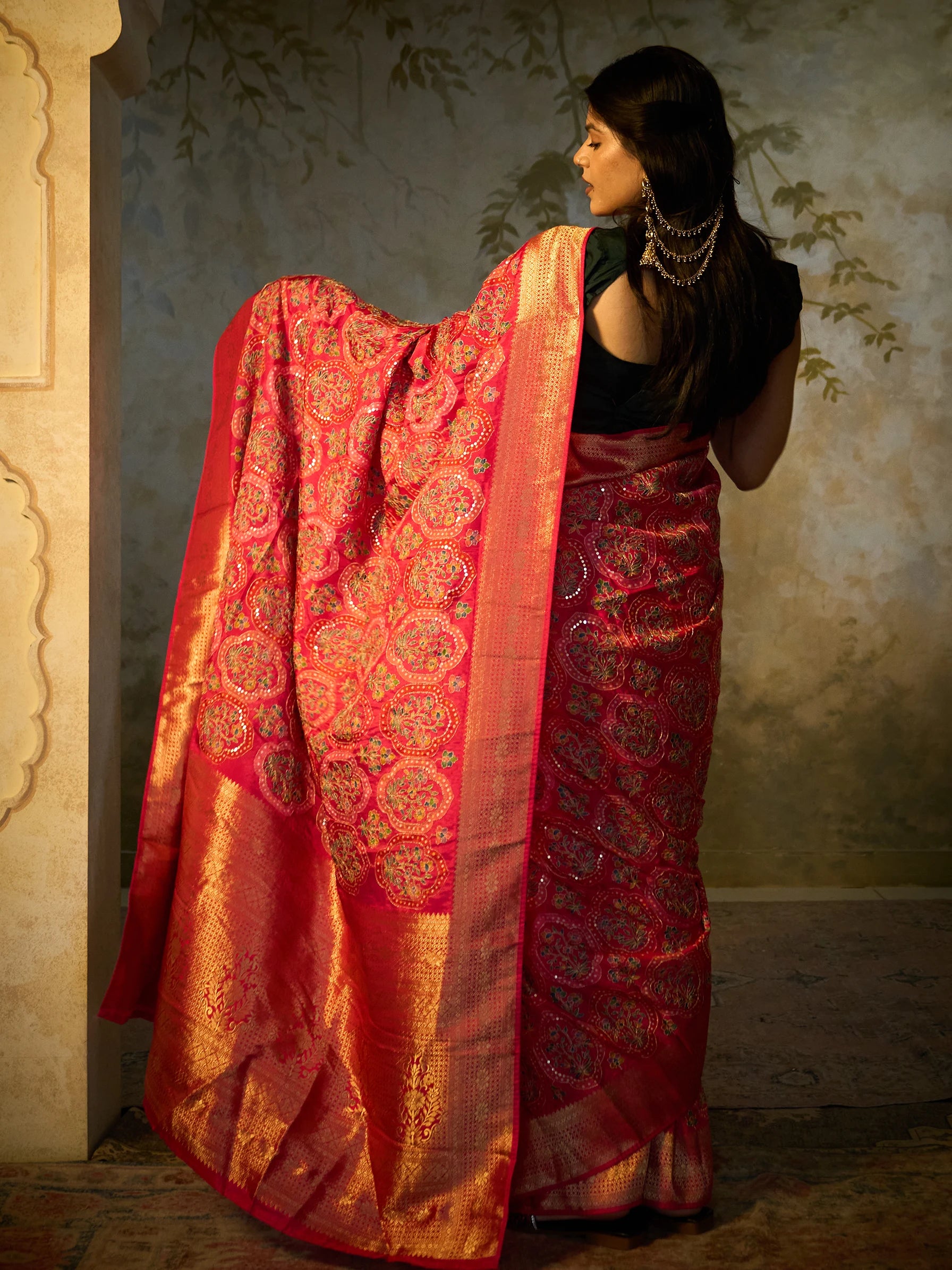 Macro detail of Zardozi metallic threadwork and sequin embellishment on floral motifs of pink Bandhani Eri silk saree